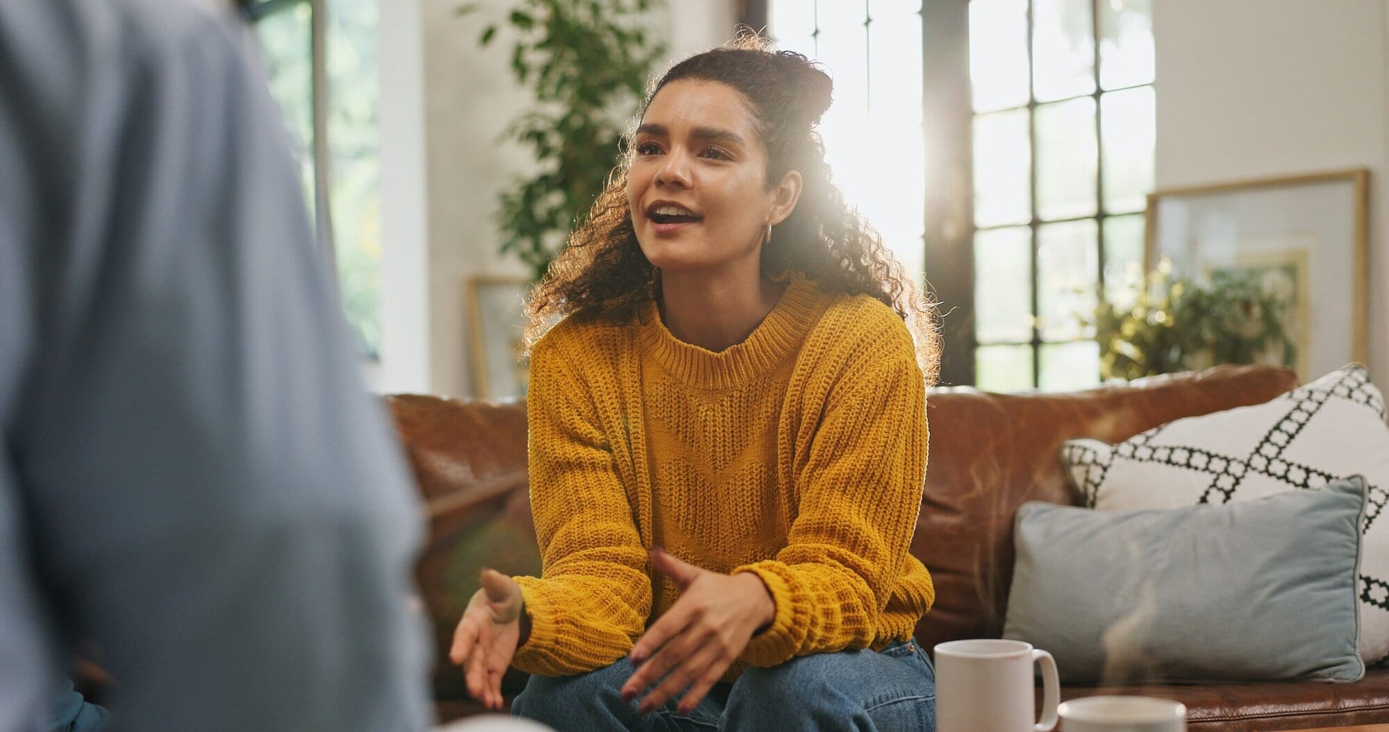 Woman sitting in a chair talking to a therapist